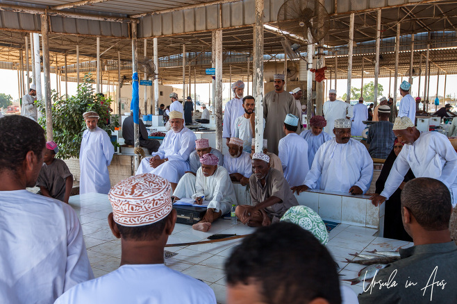 Men around the auction table, Barka Fish Market, Oman