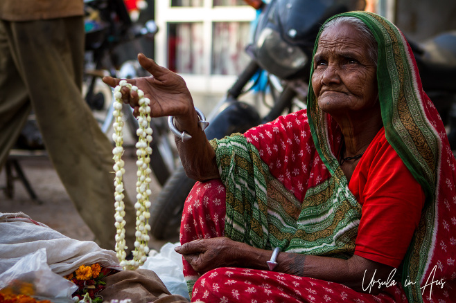 Old woman selling flowers, Varanasi, India