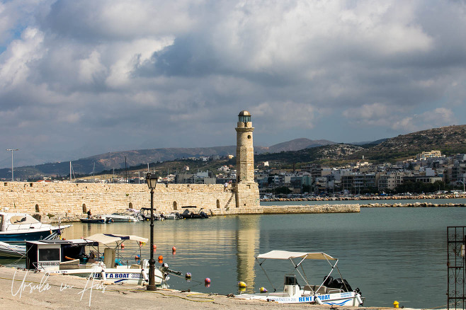 Rethymno Harbour with tour boats and the Egyptian lighthouse, Crete Greece