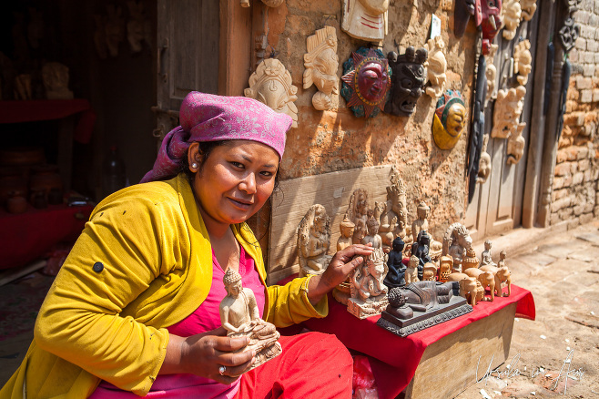 Woman selling wood carvings, Bungamati, Nepal