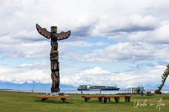 Totem Pole on Saysutshun and a container ship in the Strait of Georgia, BC Canada