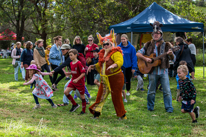 Adults in colourful costume and happy children, Panboola Wetlands, NSW Australia