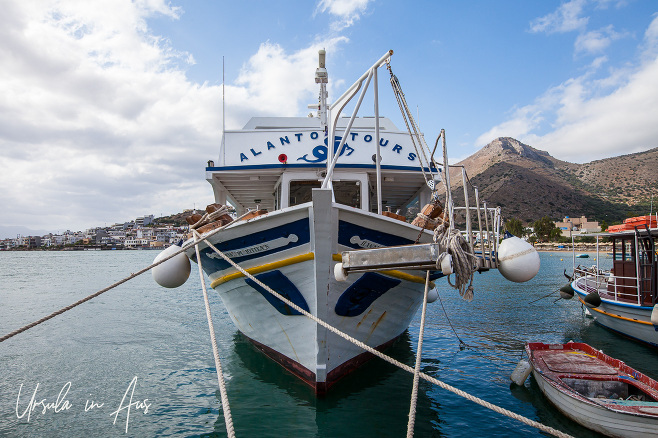 Tourist Boat, town of Plaka behind, Crete Greece.