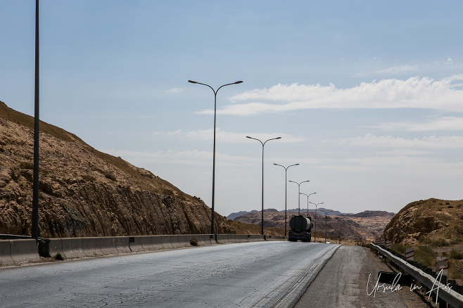 Straight highway lined with light poles, Jordan.
