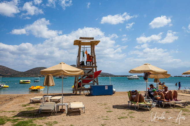 Beach umbrellas and a lifeguard station, Elounda, Crete, Greece