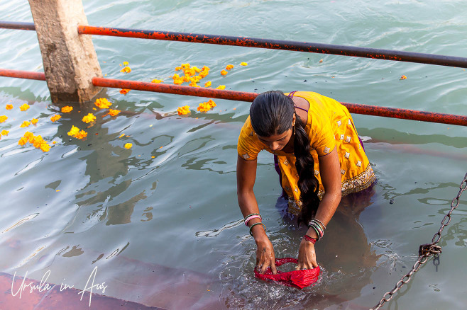 A woman in yellow in the Ganges, Haridwar India