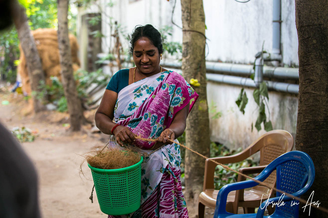 Woman twisting coconut fibre into rope, Cuddalore, Tamil Nadu India