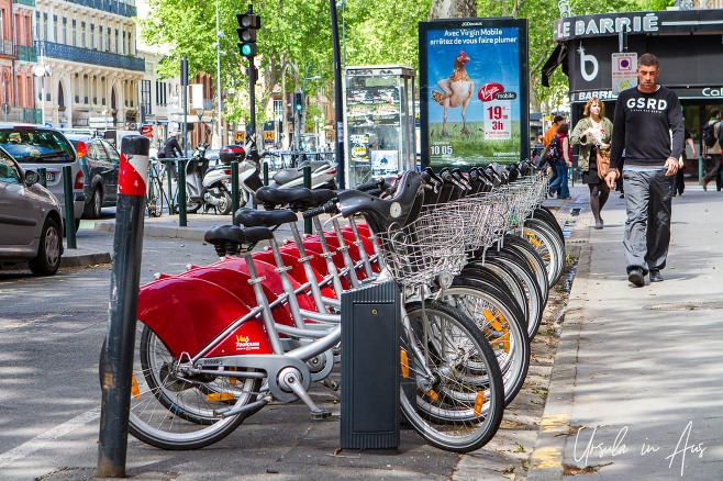 Rental bicycles in a storage rack, Toulouse, France.