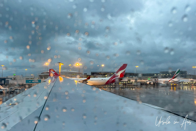 Rain over the wing of an airplane, International Departures, Sydney Airport, Australia