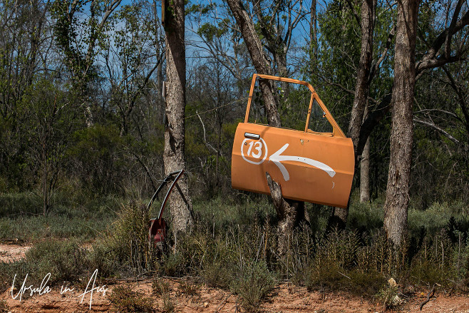 Orange car door with a directional arrow on it, Sheepyard, NSW Australia