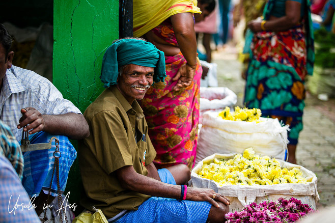 Portrait: Indian man in a green turban selling flowers, Madurai market.