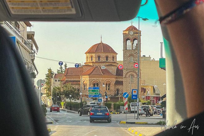 Orthodox church at the Argos crossroads through a bus windscreen, Greece