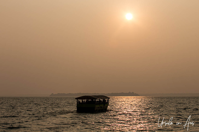 Late afternoon sun over a boat on the Kavan River, Kerala, India