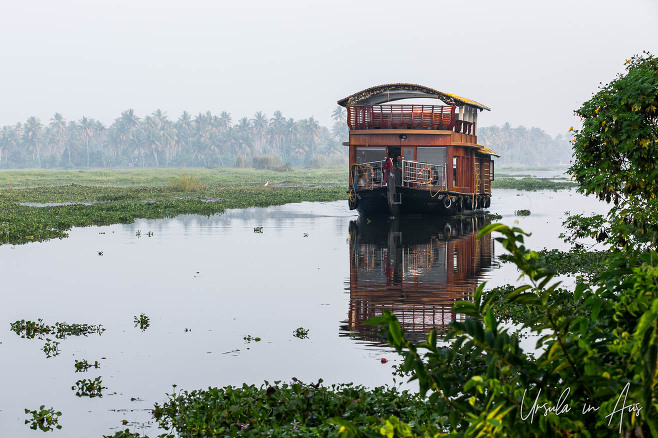 Houseboat and its reflection in the water, Vembanad Lake, Kerala, South India.