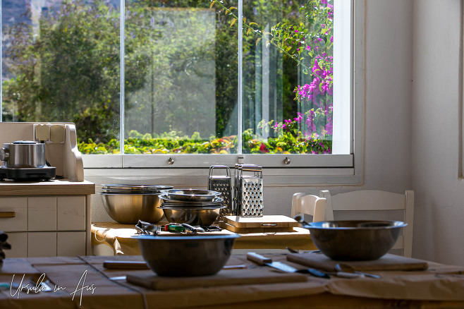 Clean cooking utensils in front of a garden window, Platia, Naxos Greece