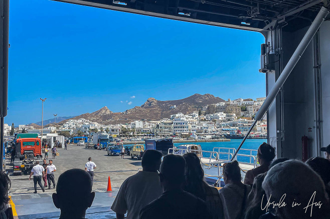 Silhouetted people exiting a ferry onto Naxos, Greece