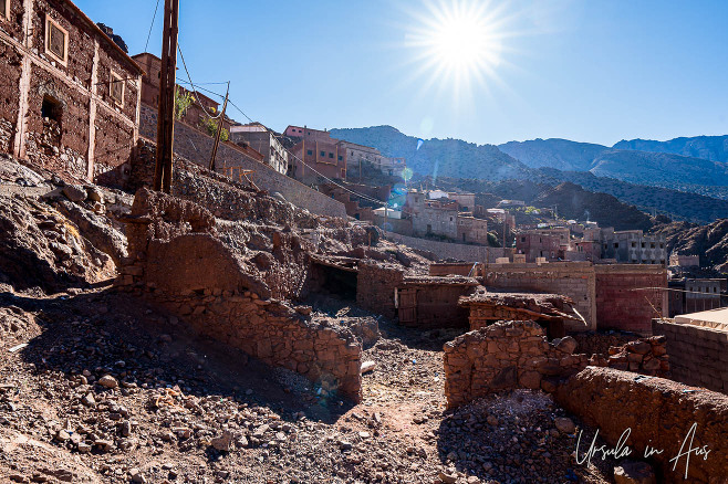 Sun flare over broken brick buildings, Aït Aïssa, Morocco 